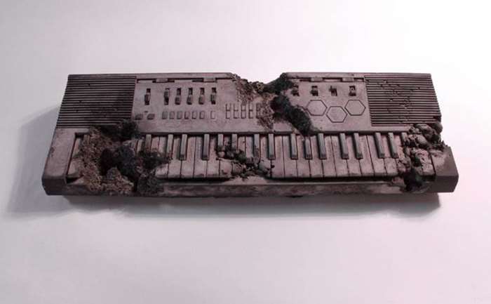 Volcanic Ash Eroded Keyboard, 2014, Volcanic ash, pulverized glass, and hydrostone, 39.5 x 133 x12.5 cm.png